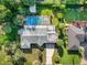 Aerial shot of a single-story home with a large in-ground swimming pool, patio, and mature landscaping at 1910 Sylvester Ct, Lakeland, FL 33803