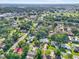 A neighborhood aerial view showcasing mature trees and a mix of single-Gathering homes at 1910 Sylvester Ct, Lakeland, FL 33803