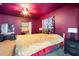 Stylish bedroom featuring a ceiling fan, ample closet space, and a modern design, creating a serene living space at 1910 Sylvester Ct, Lakeland, FL 33803