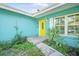 Bright yellow front door with a charming entry and well-kept landscaping at 1910 Sylvester Ct, Lakeland, FL 33803