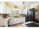Well-lit kitchen featuring white cabinets, a modern sink, and black appliances at 1910 Sylvester Ct, Lakeland, FL 33803