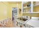 Well-lit laundry room with modern washer and dryer, storage cabinets, and view into adjacent rooms and backyard at 1910 Sylvester Ct, Lakeland, FL 33803