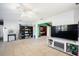 Open living room with tile floors, ample space, and a view into the bedroom at 1910 Sylvester Ct, Lakeland, FL 33803