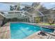 Large outdoor pool with translucent enclosure, ideal for summer swims at 1910 Sylvester Ct, Lakeland, FL 33803