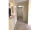 Tiled entryway leading to the front door with a partial view of the kitchen at 709 Secret Harbor Ln # 313, Lake Mary, FL 32746