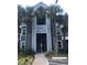 Exterior view of a multi-story condo building with palm trees and visible unit access at 709 Secret Harbor Ln # 313, Lake Mary, FL 32746