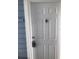Close-up of a white front door with a door knocker and electronic lockbox at 709 Secret Harbor Ln # 313, Lake Mary, FL 32746
