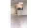 Open living space with tile floors and a view of the kitchen area at 709 Secret Harbor Ln # 313, Lake Mary, FL 32746