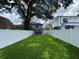 Wide fenced backyard with lush lawn and hot tub under a wood pergola at 808 Edgewater Dr, Orlando, FL 32804