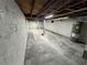 Unfinished basement with concrete floor, block walls and exposed ceiling features at 808 Edgewater Dr, Orlando, FL 32804