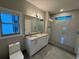 Bright bathroom featuring double sinks, lots of counter space, and a walk-in shower at 808 Edgewater Dr, Orlando, FL 32804