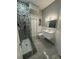 Modern bathroom with a glass enclosed shower featuring decorative tile and a sleek floating vanity at 808 Edgewater Dr, Orlando, FL 32804