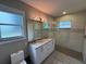 Bright bathroom featuring double sinks, decorative lighting, and a glass enclosed shower at 808 Edgewater Dr, Orlando, FL 32804
