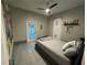 Simple bedroom featuring a modern barn door, light gray walls, and lots of natural light at 808 Edgewater Dr, Orlando, FL 32804