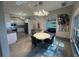Bright dining area with modern lighting, open to kitchen, and view to the lake at 808 Edgewater Dr, Orlando, FL 32804