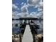 Covered dock with boat lift on a scenic lake offering a perfect waterfront lifestyle at 808 Edgewater Dr, Orlando, FL 32804