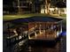 Evening view of covered dock with a boat lift, illuminated in a peaceful lakeside setting at 808 Edgewater Dr, Orlando, FL 32804