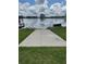 Concrete walkway leads to a dock with scenic lake views, perfect for enjoying waterfront living at 808 Edgewater Dr, Orlando, FL 32804