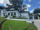 Beautiful home featuring modern architecture, a well-manicured lawn, and a detached garage at 808 Edgewater Dr, Orlando, FL 32804