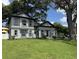 Stunning two-story home boasts a well-manicured lawn and a modern, gray color scheme at 808 Edgewater Dr, Orlando, FL 32804
