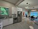 Modern kitchen with stainless steel appliances, gray backsplash, and an open dining area at 808 Edgewater Dr, Orlando, FL 32804