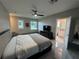 Modern main bedroom featuring a ceiling fan, neutral decor, and an ensuite bathroom at 808 Edgewater Dr, Orlando, FL 32804
