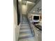 A modern stairway with gray tile, stainless handrail, and contemporary decor at 808 Edgewater Dr, Orlando, FL 32804