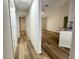 Hallway leading to the kitchen and living area with wood-look floors and neutral walls at 1737 N Lakewood Ave, Ocoee, FL 34761