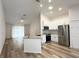 Modern open-concept kitchen featuring granite countertops, stainless steel appliances, and ample cabinet space at 1737 N Lakewood Ave, Ocoee, FL 34761