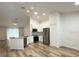 Bright and open kitchen with white cabinets, stainless steel appliances, and island with sink at 1737 N Lakewood Ave, Ocoee, FL 34761