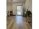 Inviting entryway and living room with wood-look flooring, neutral walls, and natural light at 1737 N Lakewood Ave, Ocoee, FL 34761
