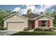 Charming single-story home with a two-car garage and well-maintained lawn at 2072 Babbling Brook Blvd, Auburndale, FL 33823