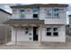 Two-story construction shows the house structure before siding. Windows are installed, with a covered porch at 2359 Zuni Road, St Cloud, FL 34771