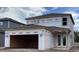 New two-story home showing an open garage and French doors under construction at 2359 Zuni Road, St Cloud, FL 34771