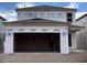 A two-story construction showing a modern garage entrance under a cloudy sky at 2359 Zuni Road, St Cloud, FL 34771