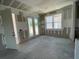 New construction shows the bare drywall with large windows and glass doors looking onto a green yard at 2359 Zuni Road, St Cloud, FL 34771