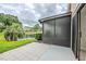 A screened-in back porch offers views of the backyard and pond at 609 Casa Park N Ct, Winter Springs, FL 32708