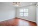 This bedroom features hardwood floors, a large window, and a ceiling fan at 609 Casa Park N Ct, Winter Springs, FL 32708