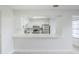 Modern kitchen showcasing white cabinets, a stainless steel refrigerator, and a sleek countertop with breakfast bar seating at 609 Casa Park N Ct, Winter Springs, FL 32708