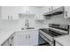 Well-equipped kitchen with quartz countertops, stainless steel appliances, and modern cabinetry, blending style and functionality at 609 Casa Park N Ct, Winter Springs, FL 32708