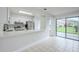 Modern kitchen area featuring stainless steel appliances and a serving hatch providing seamless connectivity to the dining area at 609 Casa Park N Ct, Winter Springs, FL 32708