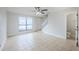 Bright living room features tile flooring and a staircase, offering ample space with convenient access to a powder room at 609 Casa Park N Ct, Winter Springs, FL 32708