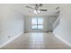 Bright living room with large window, tile flooring, and a staircase leading to the upper level in this townhome at 609 Casa Park N Ct, Winter Springs, FL 32708
