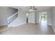 Spacious living area features tiled flooring and staircase that leads to the upper floor, enhancing the townhome's charm at 609 Casa Park N Ct, Winter Springs, FL 32708