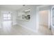 Open living area features tile flooring, a kitchen view with a serving hatch, and sliding glass doors to the backyard at 609 Casa Park N Ct, Winter Springs, FL 32708