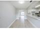 Open living space featuring tile flooring, adjacent to a modern kitchen with a bar top, offering seamless living at 609 Casa Park N Ct, Winter Springs, FL 32708