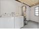 Functional basement with washer, dryer, and water heater setup at 5008 Vanguard St, Orlando, FL 32819