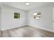 Well lit bedroom with light gray wood floors and two windows at 5008 Vanguard St, Orlando, FL 32819