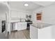 Modern kitchen featuring white cabinets, stainless steel appliances, and granite countertops at 5008 Vanguard St, Orlando, FL 32819