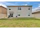 Backyard featuring a grass lawn and a beige house at 623 Grove St, Winter Haven, FL 33881
